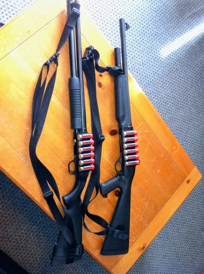 Two defensive shotguns with side saddles holding 12-gauge slugs
