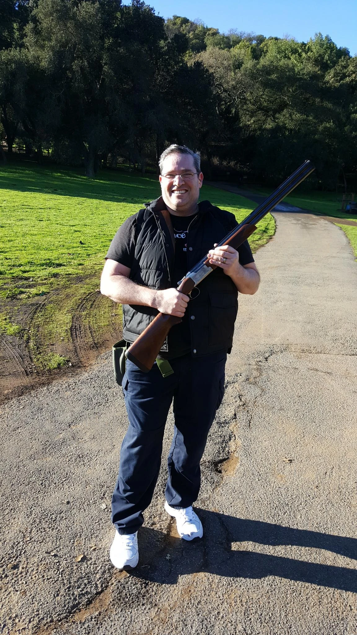 Shooter holding a Benelli over-under 12 gauge shotgun outdoors